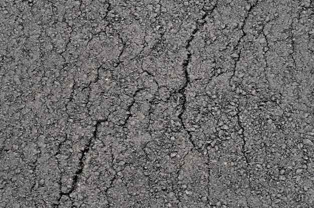 Surface of new clean cracked asphalt top view