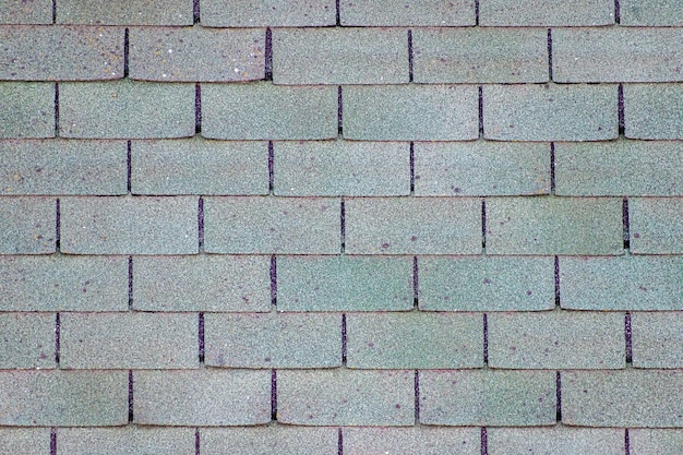 Surface of old worn asphalt shingles