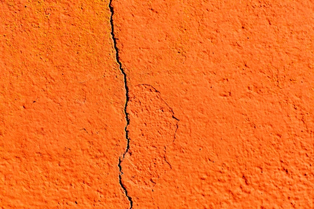 Surface of a red wall cracked 