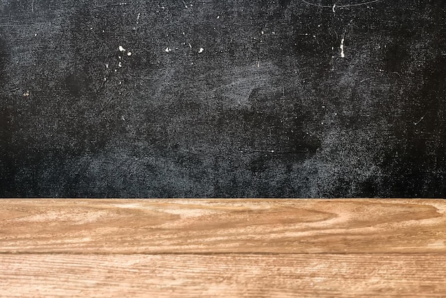 The surface of the rough wooden table top and school Board stained with chalk Abstract background