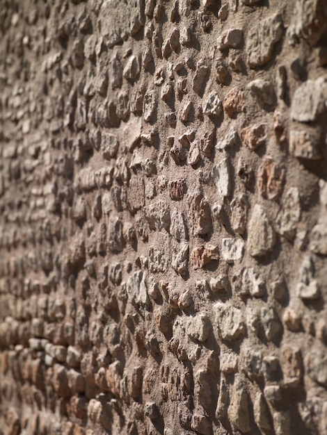 Surface of the stone wall with cracks