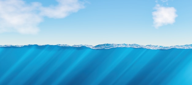 Surface and underwater view of the sea with caustics and clouds in the background