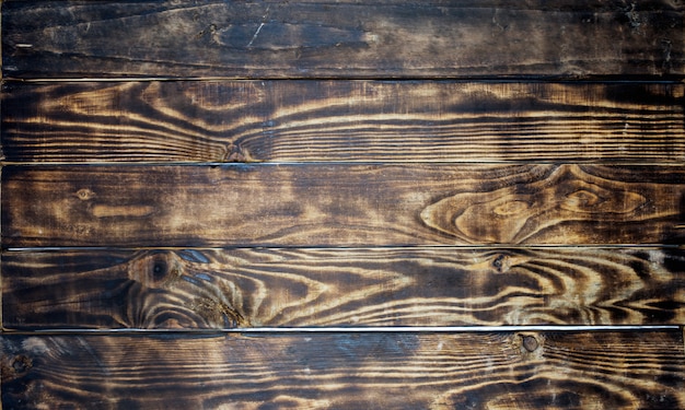 Foto superficie di vecchi pannelli di legno scuri naturali naturali d'annata, vecchia struttura di legno marrone