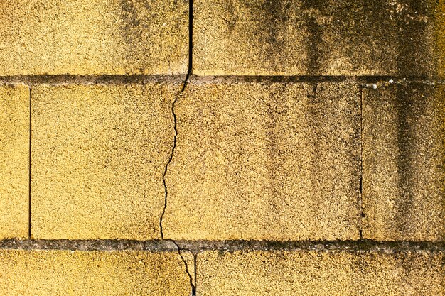 Surface of a yellow wall cracked 