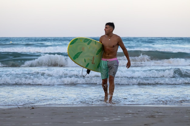 surfer on the beach with surfboard