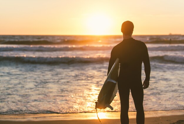 Surfer staring at the ocean