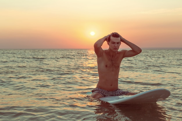 A surfer at sunset.