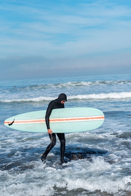 surfer walking on the beac