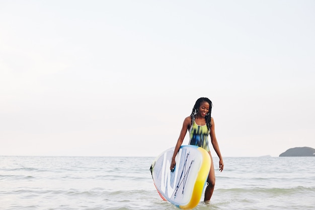 Surfer walking out of sea