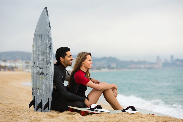 Surfers couple on the beach