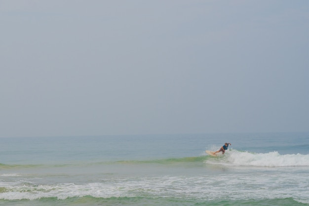 Surfers ride on a wave in the ocean.