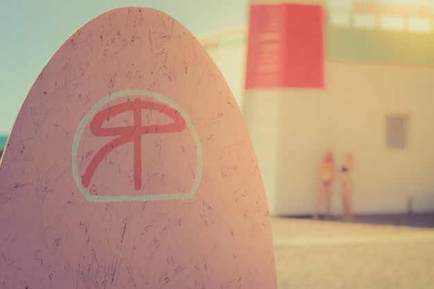 Surfing board girls on blurry sunny background Sandy beach summer vacation