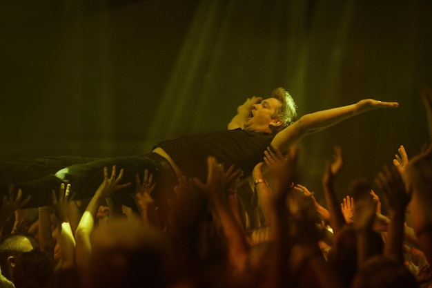 Surfing the crowd A young woman crowd surfing at a concert