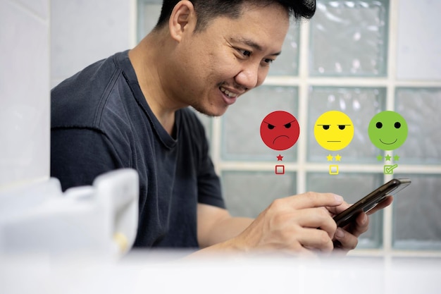 Surfing internet Closeup of male hands holding phone in restroom with a checked box on excellent smiley face