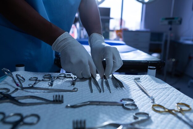 Photo surgeon arranging surgical instrument in operating room of hospital