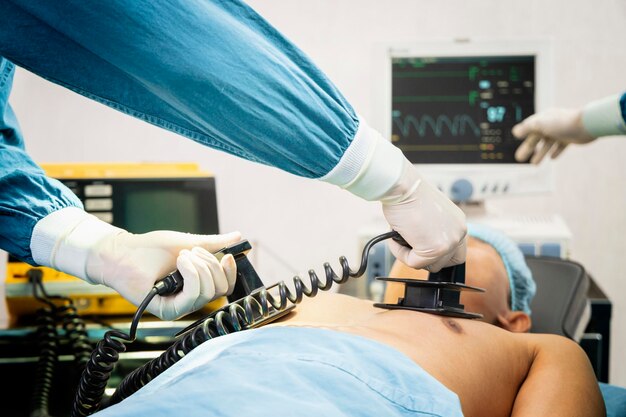 Surgeon and assistant making cpr on the patient in the\
operating room first aid emergency cardiopulmonary\
resuscitation