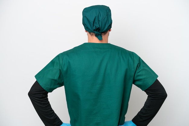 surgeon brazilian man in green uniform isolated on white background in back position