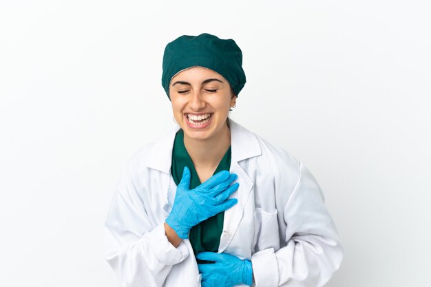 Surgeon caucasian woman isolated on white background smiling a lot