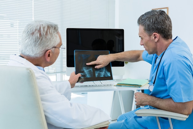 Surgeon and doctor discussing x-ray report