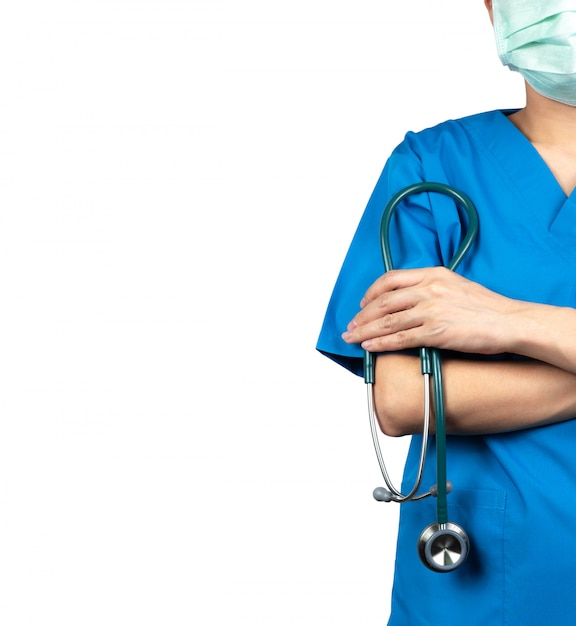 Surgeon doctor wear blue scrubs shirt uniform and green face mask. Physician stand with arms crossed and hand holding stethoscope. Healthcare professional.