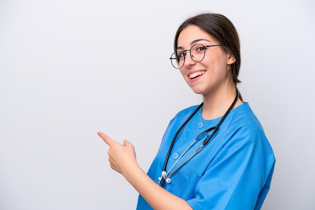 Surgeon doctor woman holding tools isolated on white background pointing back