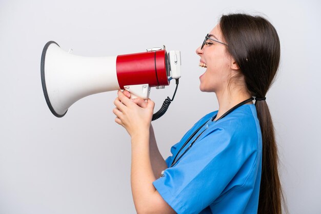 Surgeon doctor woman holding tools isolated on white background shouting through a megaphone