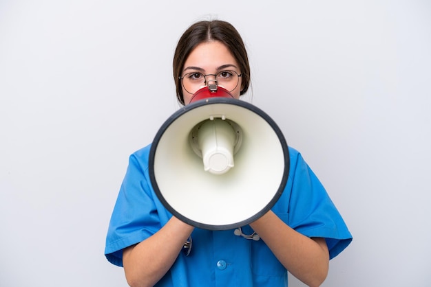 Surgeon doctor woman holding tools isolated on white background shouting through a megaphone