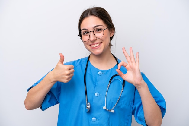 Surgeon doctor woman holding tools isolated on white background showing ok sign and thumb up gesture