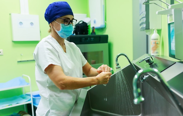 Surgeon in the hospital washing hands