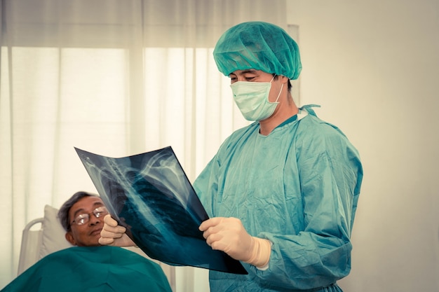 Surgeon looking at x-ray film