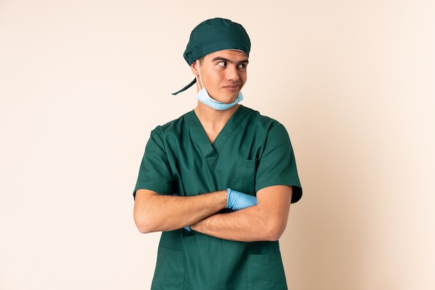 Surgeon man in blue uniform over isolated background thinking an idea