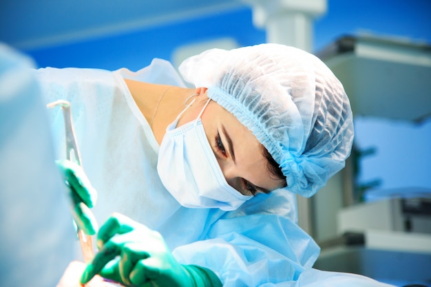 Surgeon operating a patient in operating room