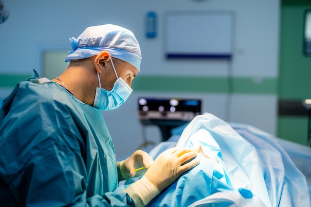 Surgeon performing complex surgery in the intensive care unit