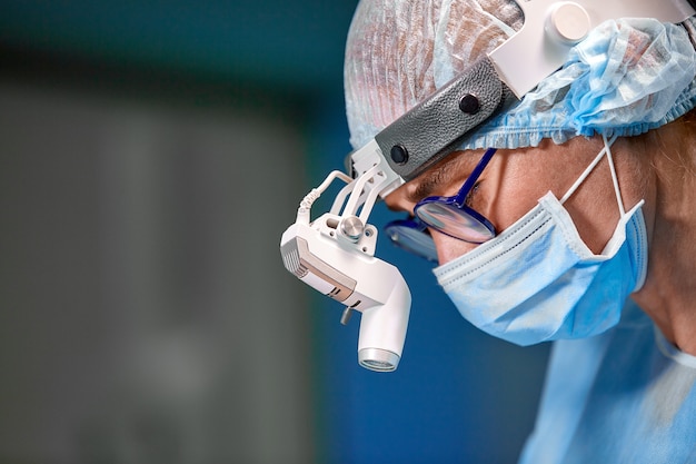 Surgeon performing cosmetic surgery in hospital operating room