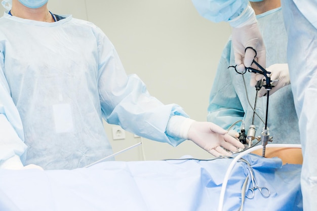 Surgeon performs laparoscopic surgery on the abdomen Closeup of a laparoscope and doctor's hands