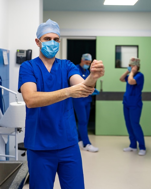 Surgeon preparing hands for surgery Professional doctors wear sterile clothing before surgery