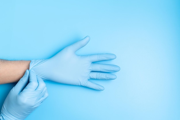 Surgeon putting medical gloves on