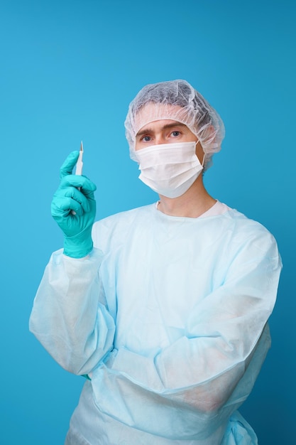 Surgeon in sterile blue uniform medical gloves and mask