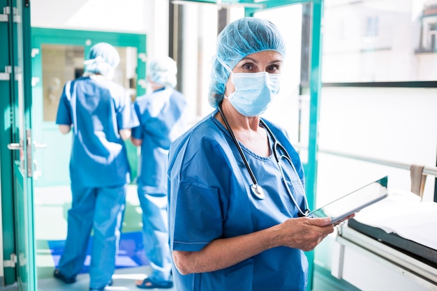 Surgeon using digital tablet in corridor