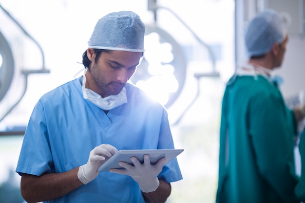 Surgeon using digital tablet in operation room