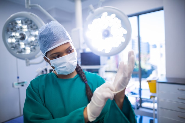 Surgeon wearing surgical gloves in operation theater