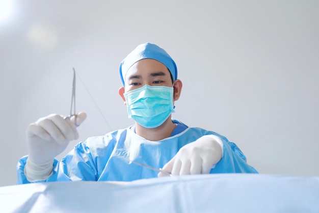 surgeon with surgical mask in Hospital Operating Theater.