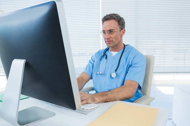 Surgeon working on personal computer