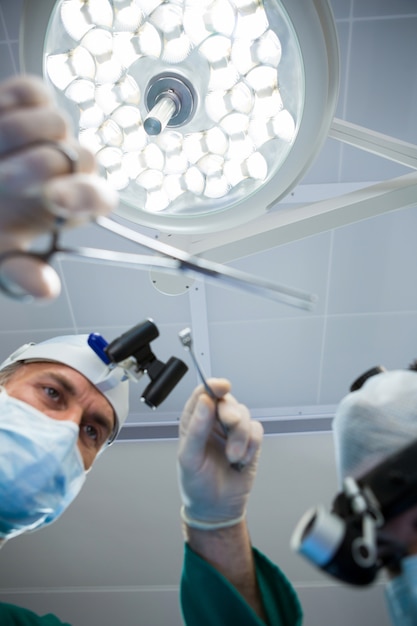 Surgeons holding surgical tool