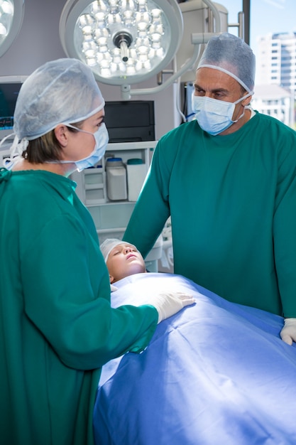 Surgeons interacting while operating patient