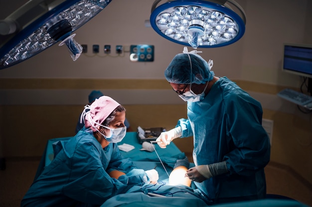 Surgeons and nurse during a surgery