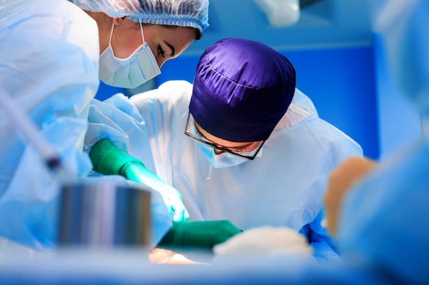 Surgeons operating a patient in operating room