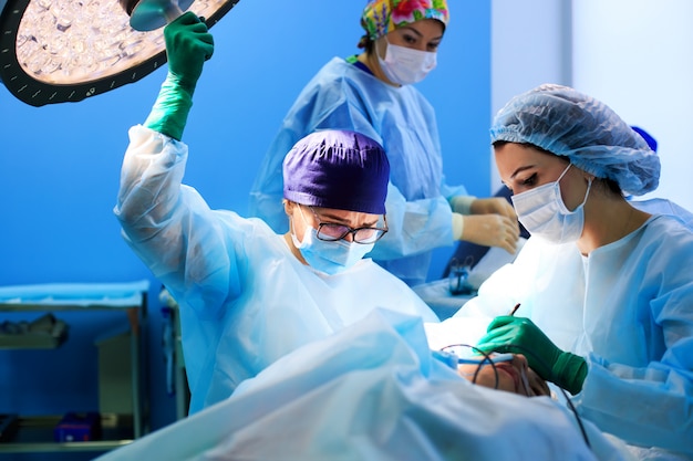 Surgeons operating a patient in operating room