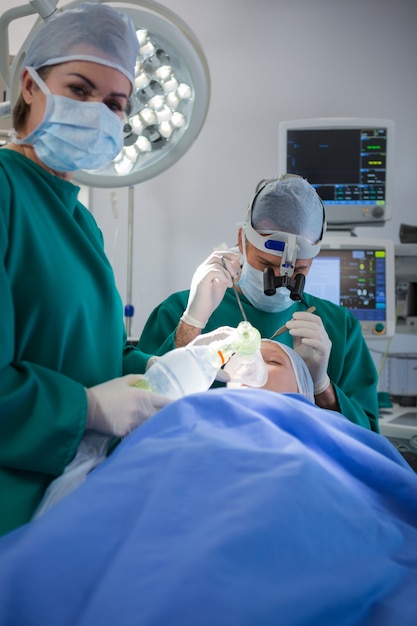 Surgeons operating patient