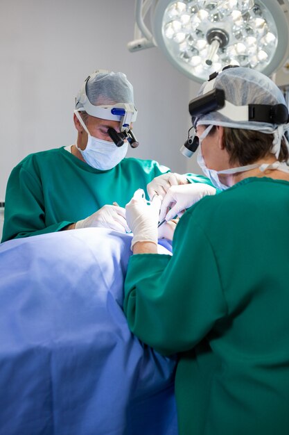 Surgeons operating patient